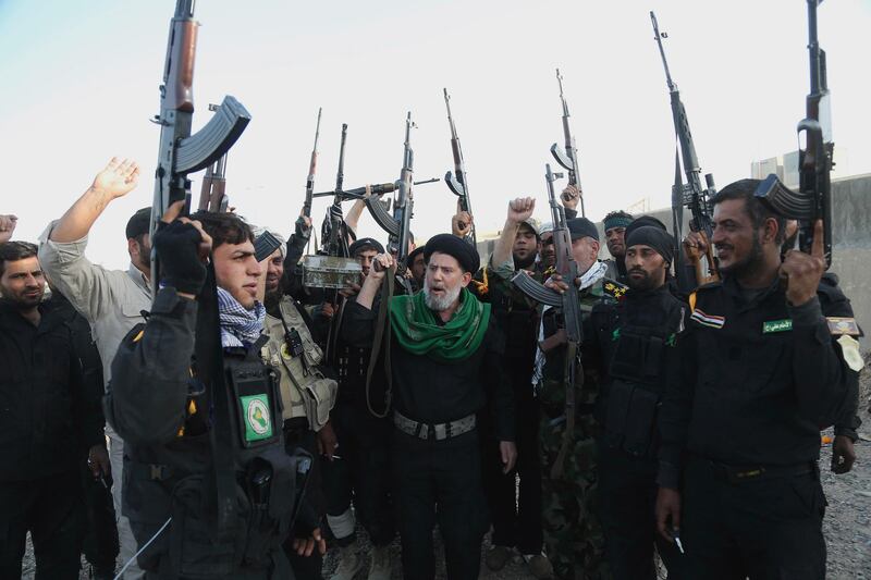 FILE - In this March 14, 2015 file photo, Iraqi Shiite militia group called Imam Ali Brigades chant slogans against the Islamic State group at the battlefield in Tikrit, 130 kilometers (80 miles) north of Baghdad, Iraq. From Lebanon and Syria to Iraq, Yemen, and the Gaza Strip, Iran has significantly expanded its footprint over the past decade, finding and developing powerful allies in conflict-ravaged countries across the Middle East. Iran has trained, financed, and equipped Shiite militias in Iraq that battled U.S. forces in the years after the 2003 invasion and remobilized to battle the Islamic State group a decade later. (AP Photo/Khalid Mohammed, File)