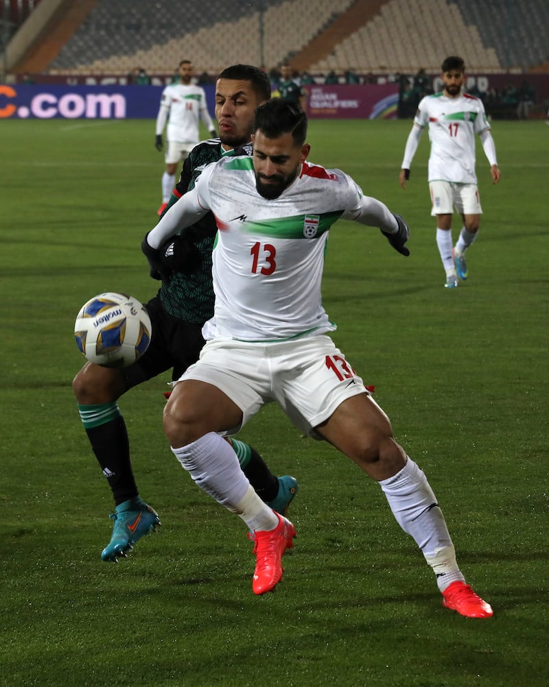 Iran's Hossein Kanani under pressure from Ali Saleh of the UAE. AP