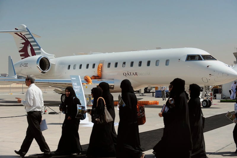 Visitors walk past a Qatar Executive aircraft during the Abu Dhabi Air Expo at Al Bateen Executive Airport in Abu Dhabi, March 5, 2013. Air Expo, the general aviation exhibition runs from March 5 to March 7. REUTERS/Ben Job (UNITED ARAB EMIRATES - Tags: TRANSPORT BUSINESS) *** Local Caption ***  ABU02_ABU-DHABI-_0305_11.JPG