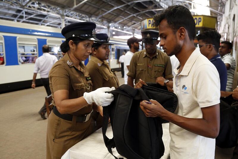 A security personnel checks the bag of a passenger at Fort train station. EPA