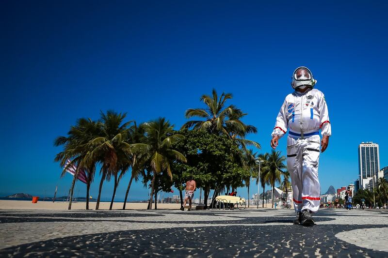 Accountant Tercio Galdino, dressed as an astronaut, walks along Copacabana beach to draw attention to the protective measures against coronavirus during the closing of the beaches according to a municipal decree to curb the spread of Covi-19 on March 21, 2021 in Rio de Janeiro, Brazil. Getty Images