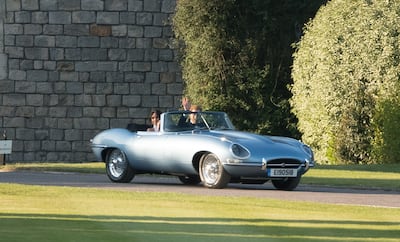 Prince Harry and Meghan Markle leave Windsor Castle in an E-Type Jaguar after their wedding. Getty Images