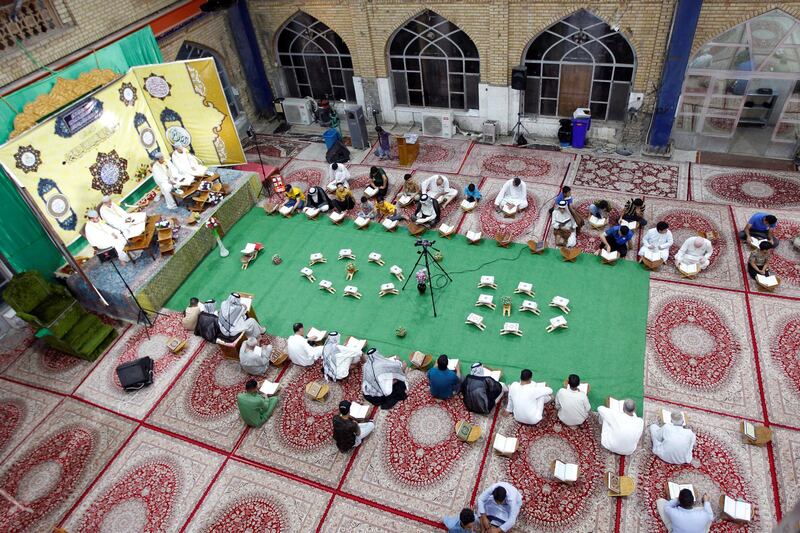 Men read at Al Qasim Mosque during the blessed month of Ramadan in Hilla, Iraq. Reuters