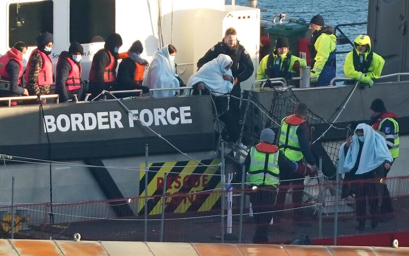 A group of people thought to be migrants are brought into Dover, Kent. PA