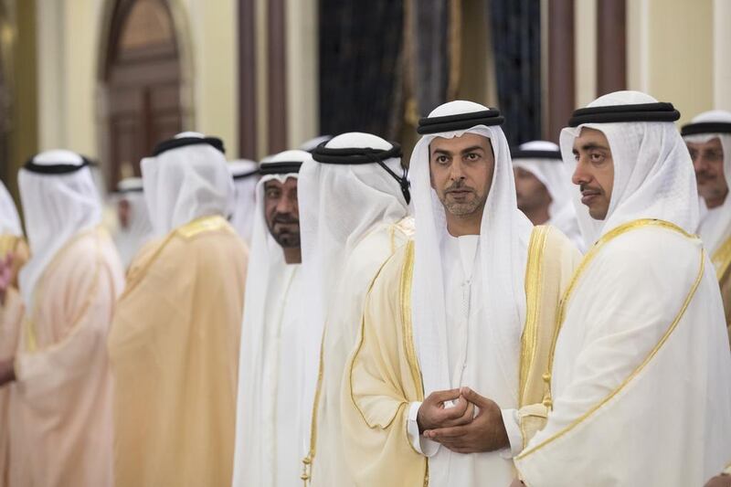 Sheikh Abdullah bin Zayed, Minister of Foreign Affairs and International Cooperation, right, and Sheikh Omar bin Zayed Al Nahyan, Deputy Chairman of the Board of Trustees of Zayed bin Sultan Al Nahyan Charitable and Humanitarian Foundation, second right, attend an Eid Al Fitr reception. Ryan Carter / Crown Prince Court - Abu Dhabi