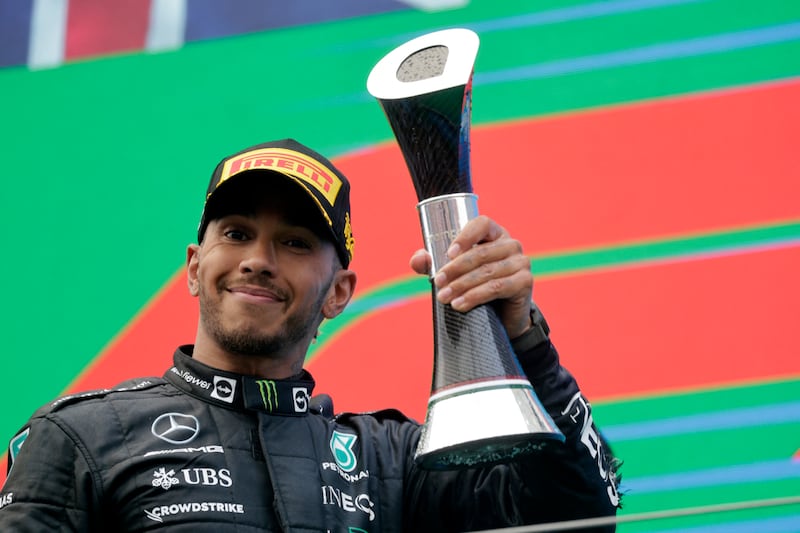 Mercedes' Lewis Hamilton celebrates on the podium after finishing in second place. Reuters
