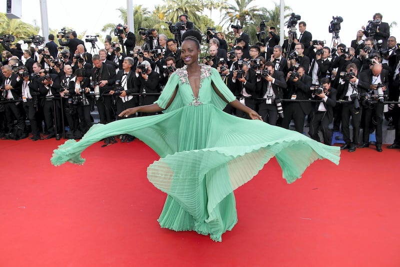Mexican-Kenyan actress Lupita Nyong'o poses as she arrives for the opening ceremony of the 68th Cannes Film Festival in Cannes, southeastern France, on May 13, 2015.   AFP PHOTO / VALERY HACHE (Photo by VALERY HACHE / AFP)