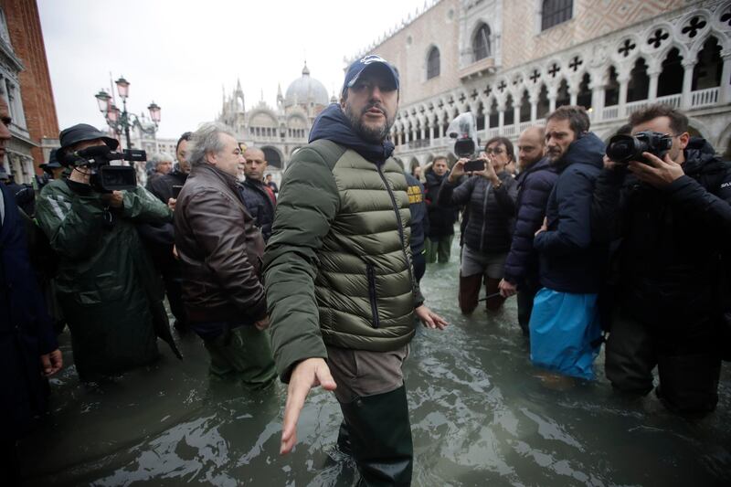 The League leader Matteo Salvini speaks to reporters as he walks in a flooded St. Mark's Square at Venice. AP Photo
