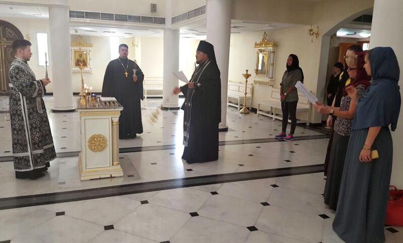 Alexander Zarkeshev, rector of the Russian Orthodox Church in Sharjah, conducts a prayer for the victims. Thaer Zriqat / The National