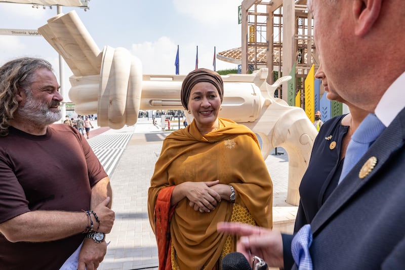 Amina Mohammed, Deputy Secretary-General of the United Nations and Chair of the United Nations Sustainable Development Group and Claes Kalborg, partner of the non-violence project foundation and Ulrich John, founder of the Original Voice Trust, pictured during the inauguration of the Wooden Knotted Gun at the Sweden Pavilion.