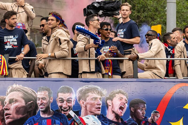 Barcelona men's players enjoy the open-top bus parade through the city of Barcelona to celebrate winning the 2022/23 La Liga title. Getty Images