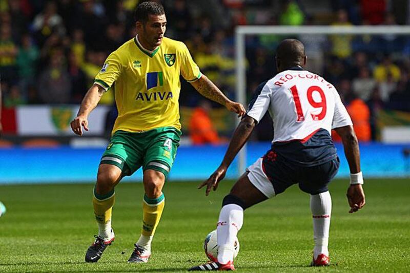 Bradley Johnson attempts to dribble past the Bolton midfielder Nigel Reo-Coker.

Clive Brunskill / Getty Images
