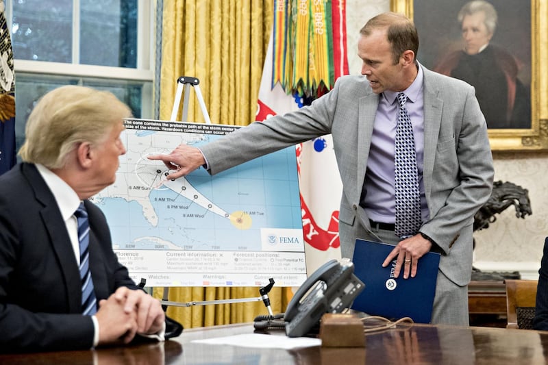 U.S. President Donald Trump, left, listens as Brock Long, administrator of the Federal Emergency Management Agency (FEMA), points to a map of the probable path of Hurricane Florence during a meeting with the Department of Homeland Security (DHS) in the Oval Office of the White House in Washington, D.C., U.S., on Tuesday, Sept. 11, 2018. Trump said he expects Florence to be among the worst storms to ever strike the U.S., but that the federal government was prepared to respond to the disaster. Photographer: Andrew Harrer/Bloomberg