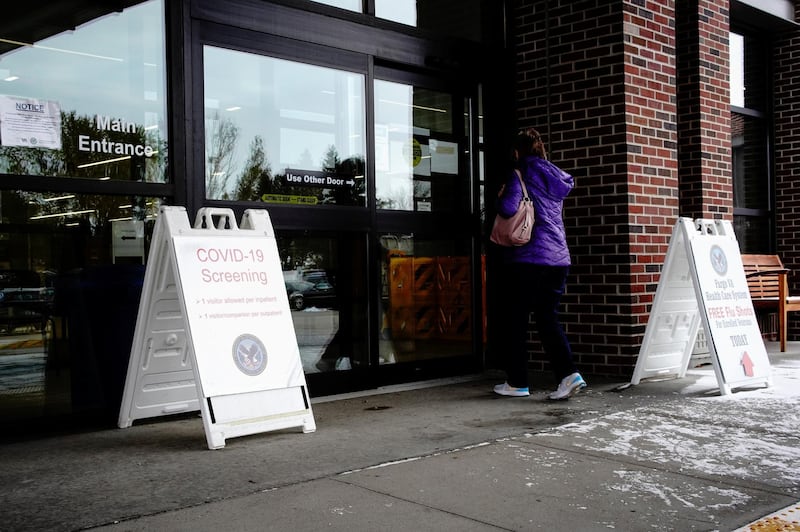 An elderly woman walks past a sign for COVID-19 screening as she enters the Fargo VA Health Care System, a Veterans Affairs hospital, as the coronavirus disease (COVID-19) outbreak continues in Fargo, North Dakota, U.S. REUTERS