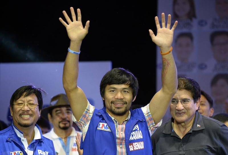 Philippine boxing champion Manny Pacquiao celebrates his senate vote victory. Noel Celis / AFP
