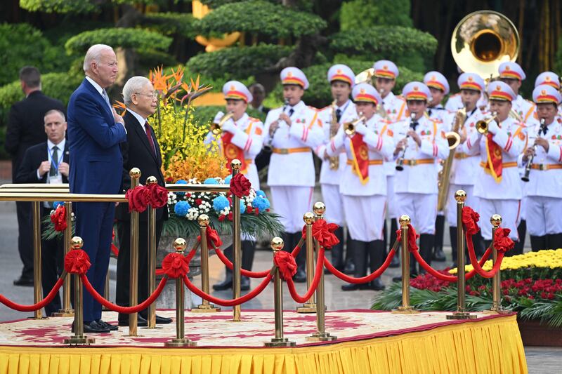 US President Joe Biden attends a welcoming ceremony hosted by Vietnam's Communist Party General Secretary Nguyen Phu Trong (2L) at the Presidential Palace of Vietnam in Hanoi. AFP