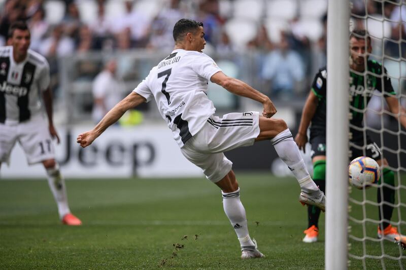 Juventus' Portuguese forward Cristiano Ronaldo scores his first goal for Juventus during the Italian Serie A football match Juventus vs Sassuolo on September 16, 2018 at the Juventus stadium in Turin. (Photo by Marco BERTORELLO / AFP)