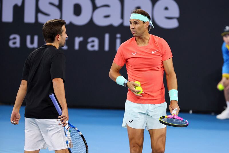 Rafael Nadal, right, talks to Marc Lopez. AP