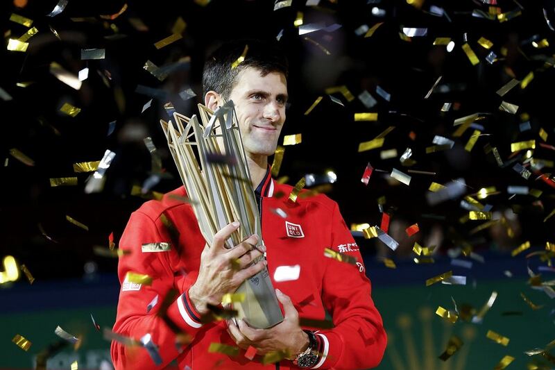 Novak Djokovic poses with the winner's trophy after defeating Jo-Wilfried Tsonga in the Shanghai Masters final. Lintao Zhang / Getty Images
