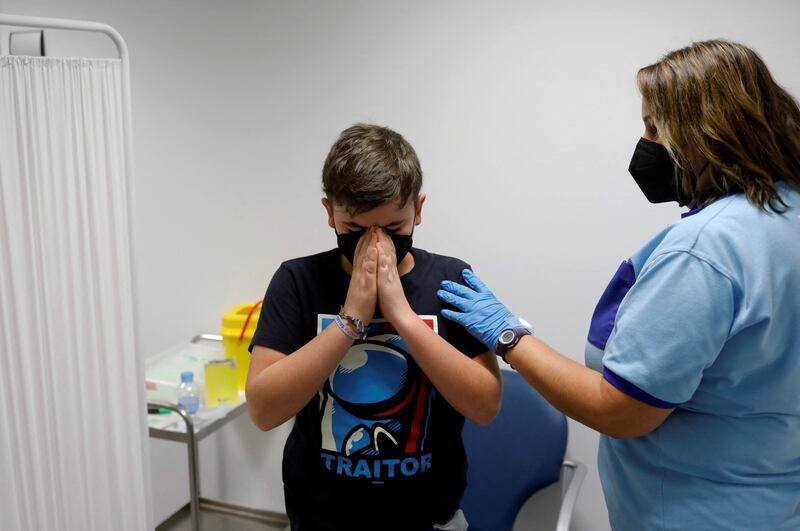 Rodrigo Rojas Morilla, 11, gets ready to receive his first dose of the Covid-19 vaccine at the La Serrania de Ronda hospital, in southern Spanish town of Ronda. Reuters