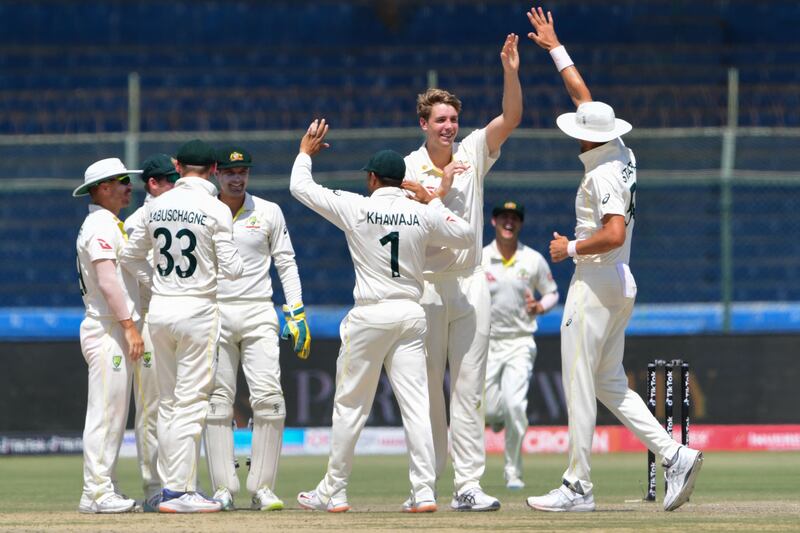 Australia bowler Cameron Green, second right, celebrates with teammates after taking the wicket of Pakistan's Azhar Ali for six. AFP