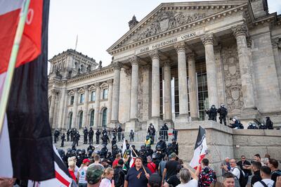 The black, white and red imperial German flag is flown in front of parliament during a coronavirus protest in 2020. Getty 