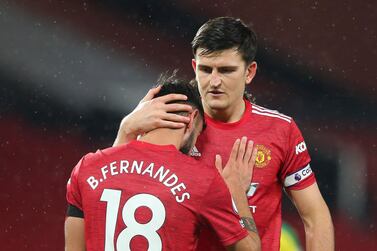 Harry Maguire with Bruno Fernandes after he scores with his second attempt from the penalty spot. EPA
