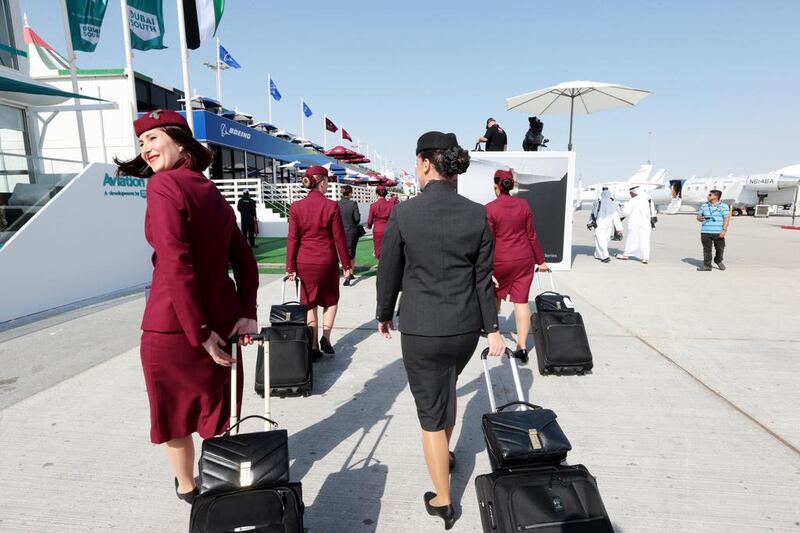 A group of Qatar Airways flight crew arrive at the Dubai Airshow. Christopher Pike / The National