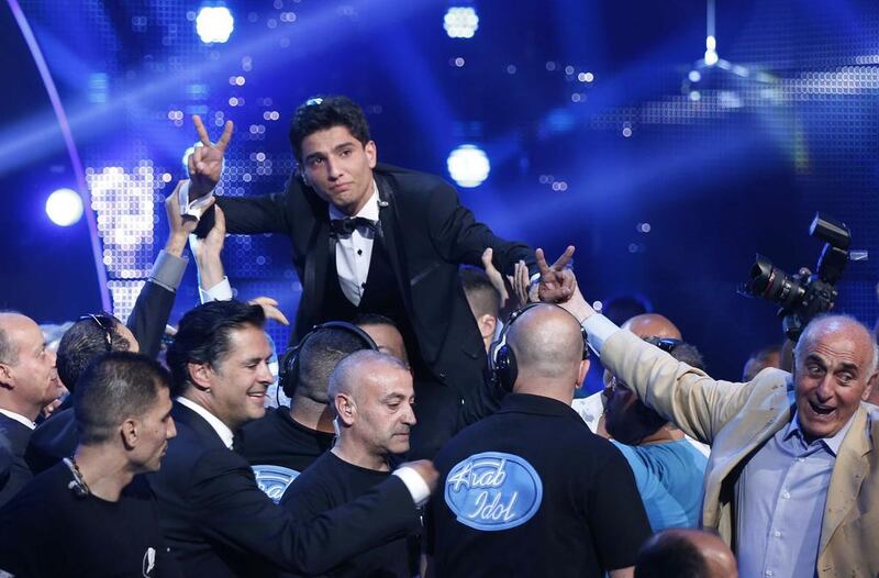 Palestinian singer Mohammed Assaf celebrates winning Arab Idol in 2013. Mohammed Azakir / Reuters  