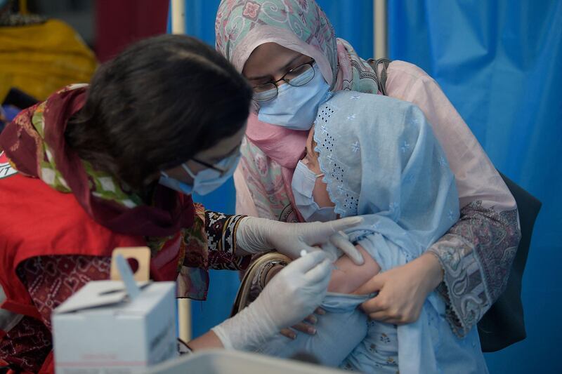 A woman is inoculated with the Sinovac Covid-19 vaccine at the Red Crescent vaccination centre in Rawalpindi, Pakistan. AFP
