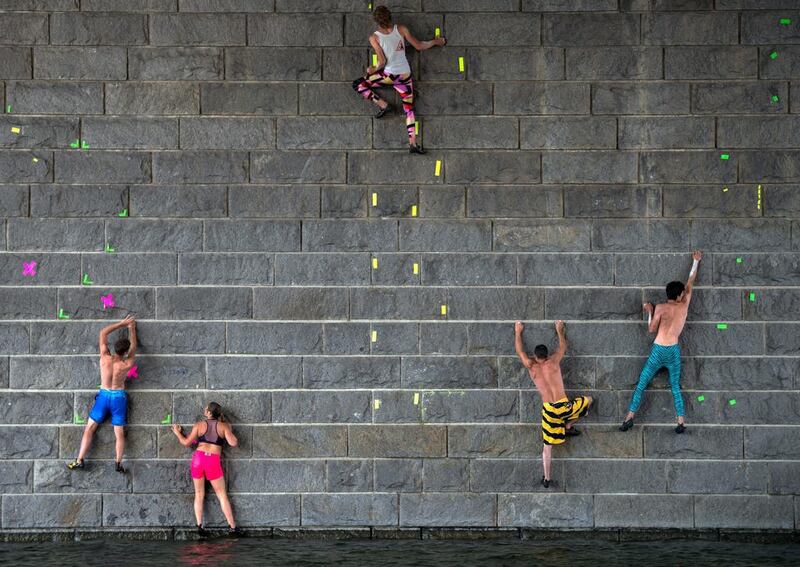 Participants climb up a pier wall on the Danube during the ‘Urban Waters Cup 2016’ competition in Vienna. Christian Bruna / EPA