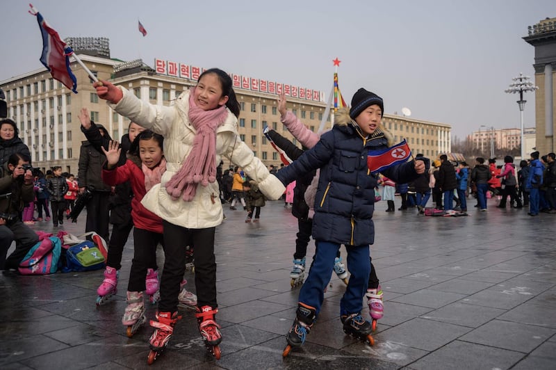 Children play traditional games on Mansu Hill in Pyongyang, North Korea. AFP