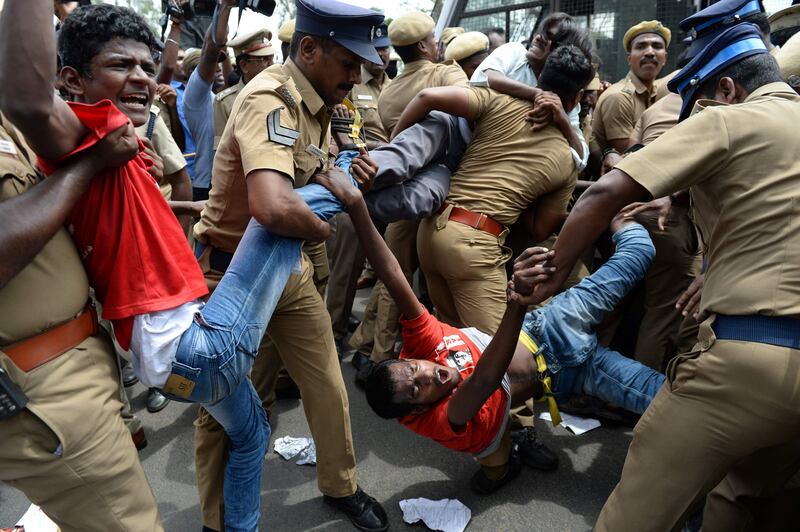 File photo from May 2017 showing Indian police removing members of the Revolutionary Students and Youth Front during a protest the ban on the sale of cows for slaughter in Chennai. India's top court on July 11, 2017 stayed a nationwide ban imposed by the government on the sale of cattle for slaughter that had provoked outcry in many states.
Arun Sankar/AFP Photo