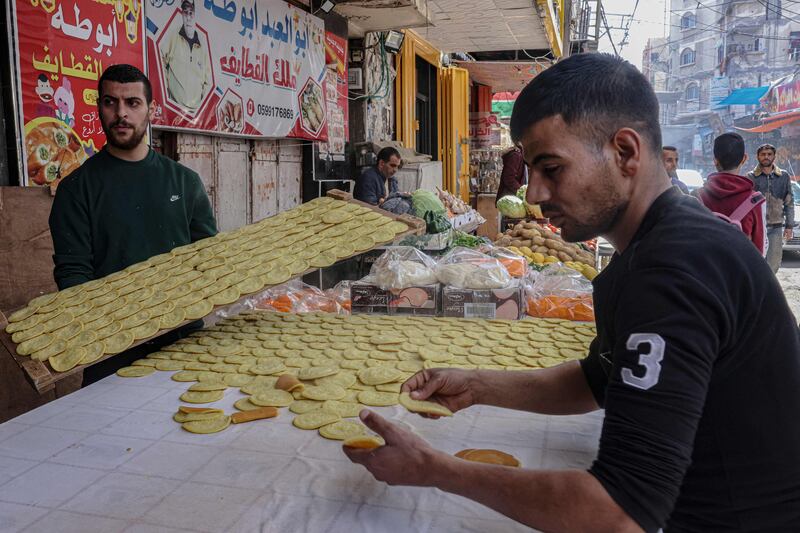 Palestinians prepare traditional 'Qatayef' sweets. AFP