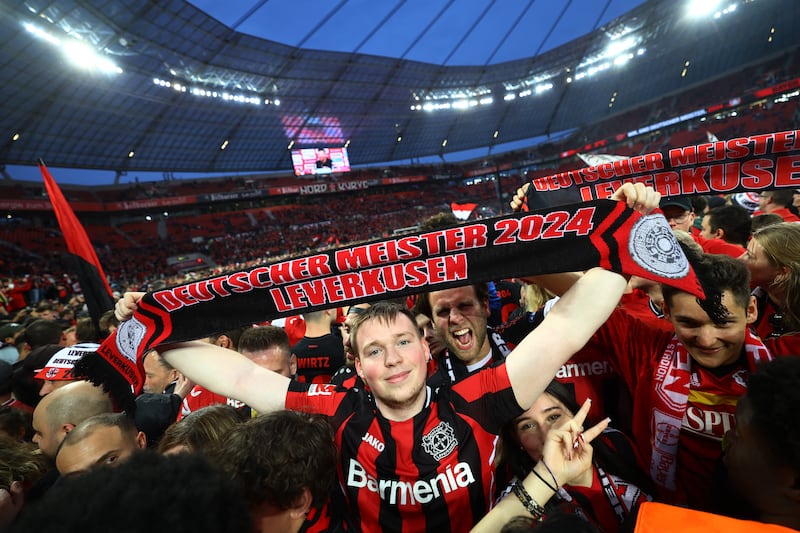 Bayer Leverkusen fans on the pitch. Reuters 