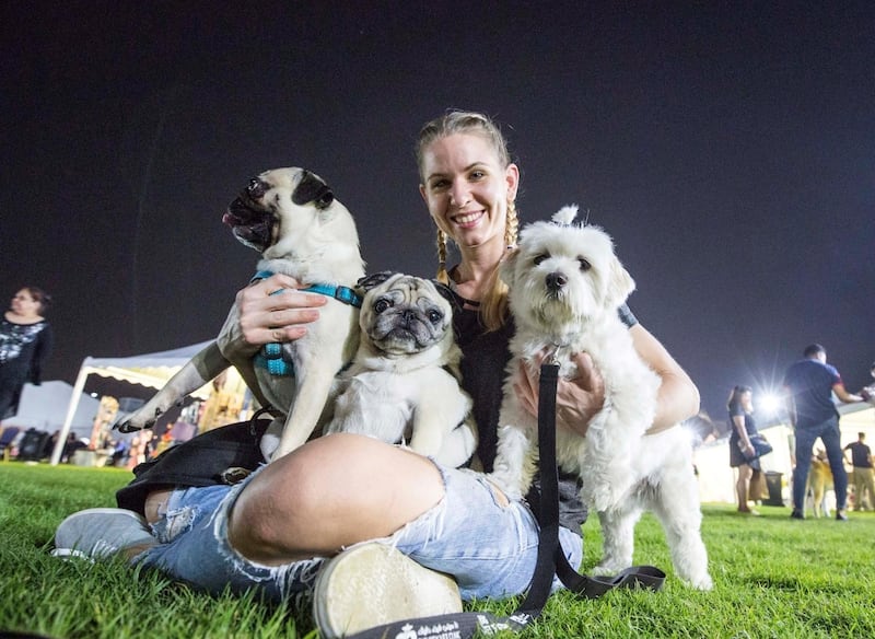 ABU DHABI, UNITED ARAB EMIRATES, 28 OCTOBER 2018 - A proud pet owner with her 3 adorable dogs at the inaugural of Yas Pet Together event at Yas Du Arena, Abu Dhabi.  Leslie Pableo for The National for Evelyn Lau's story