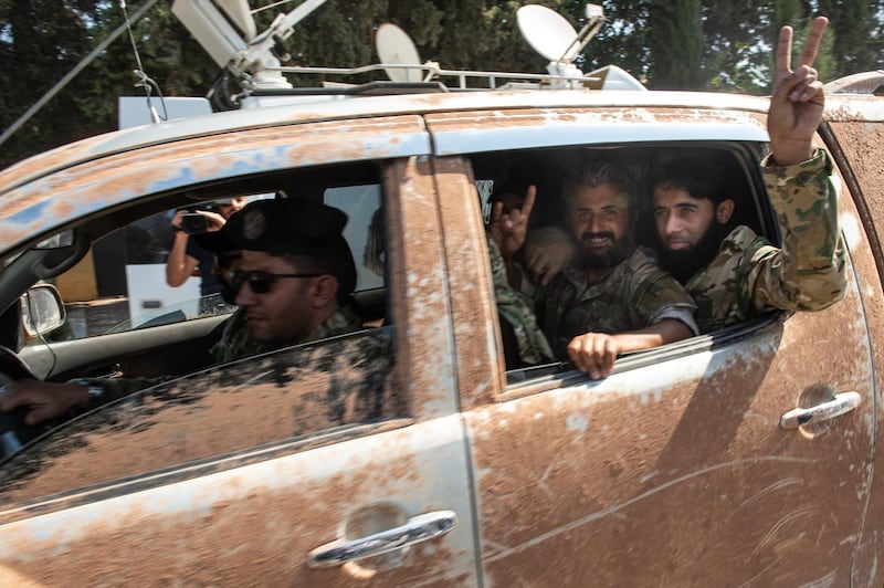 Members of the Turkish-backed Free Syrian Army, a militant group active in parts of northwest Syria, patrol the Turkish side of the border between Turkey and Syria in Akcakale, Turkey. The forces are participating in a campaign to extend Turkish control of more of northern Syria, a large swath of which is currently held by Syrian Kurds, whom Turkey regards as a threat. U.S. President Donald Trump granted tacit American approval to this military campaign, withdrawing his country's troops from several Syrian outposts near the Turkish border. Getty Images