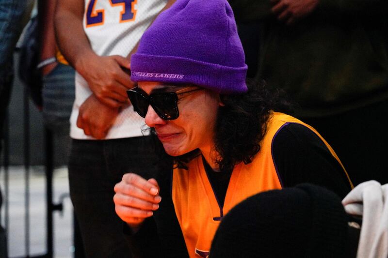 A mourner reacts while gathering with others in Microsoft Square near the Staples Center to pay respects to Kobe Bryant after a helicopter crash killed the retired basketball star, in Los Angeles, California, U.S. REUTERS