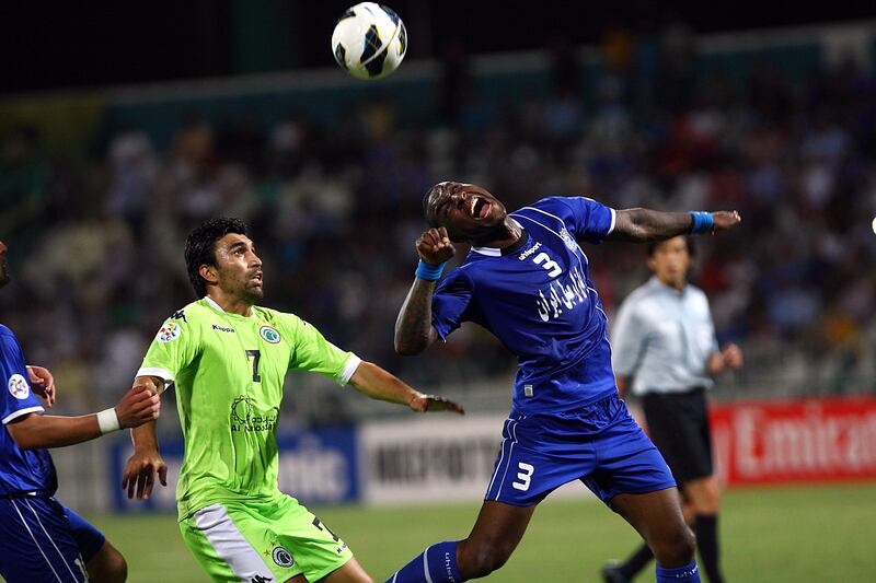 Dubai United Arab Emirates- May,15, 2013:   (L)   Azizbek Haydarov of Al Shabab (UAE)  and (L)  Jlloyd Samuel  of Esteghlal (Iran) in action during the AFC Championships League match at  the Al Shabab Stadium in Dubai.  (  Satish Kumar / The National ) For Sports