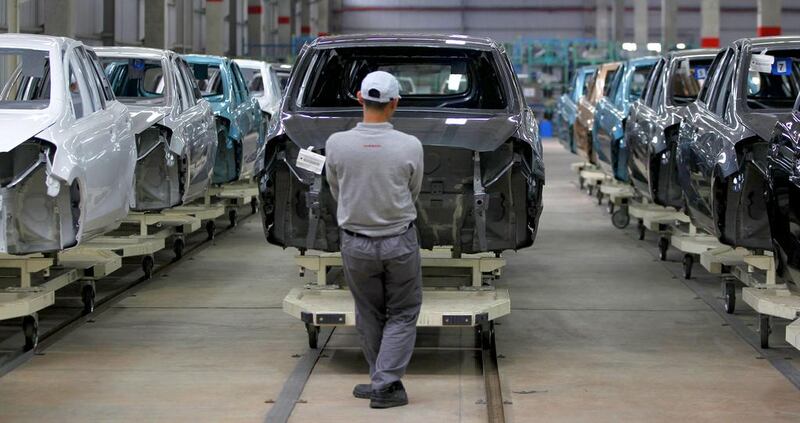 A worker transports a body of Datsun Go+ at an assembly line in the Nissan Indonesia factory. Japanese car maker Nissan said it plans to increase sales in Indonesia by 55 per cent in the year ending March 2015. Beawiharta / Reuters