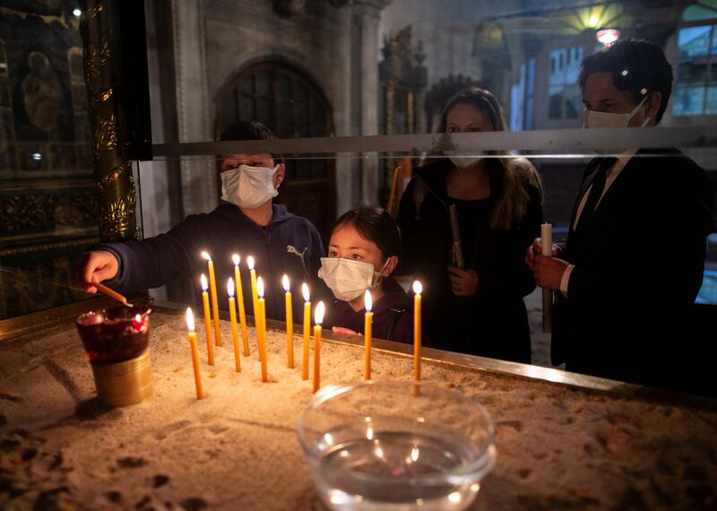 Worshippers light candles before an Easter service at the Patriarchal Cathedral of St. George in Istanbul, Turkey. Reuters