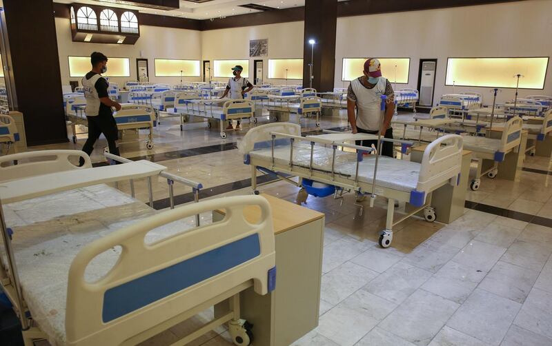 Iraqi volunteers with the Aqiq Institution for Charity work on building a 525-bed field hospital at the Baghdad International Fair exhibition centre in the capital Baghdad.  AFP