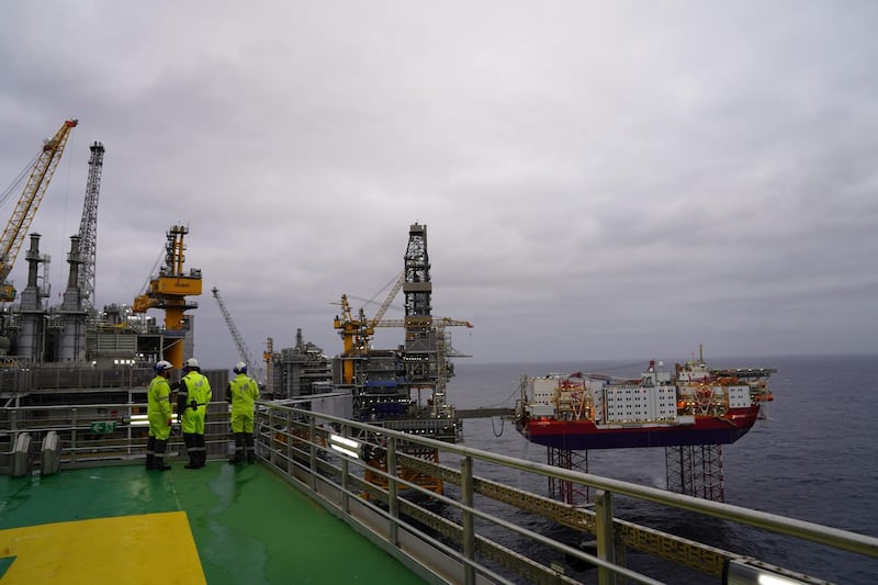Journalists and employees of Norwegian oil producer Equinor look out at the platforms producing oil above the Johan Sverdrup oilfield during a media visit, in the North Sea 140 kilometres west of the town of Stavanger, Norway, on December 3, 2019. Norway's King Harald will formally inaugurate the field in January 2020, but production began back in early October 2019 and 350,000 barrels are already being pumped up per day. 
Fifty years after the Scandinavian country first struck black gold, the field holds the promise of another half-century of oil business, despite growing opposition to fossil fuels.       / AFP / Tom LITTLE / TO GO WITH AFP STORY by Pierre-Henry DESHAYES
