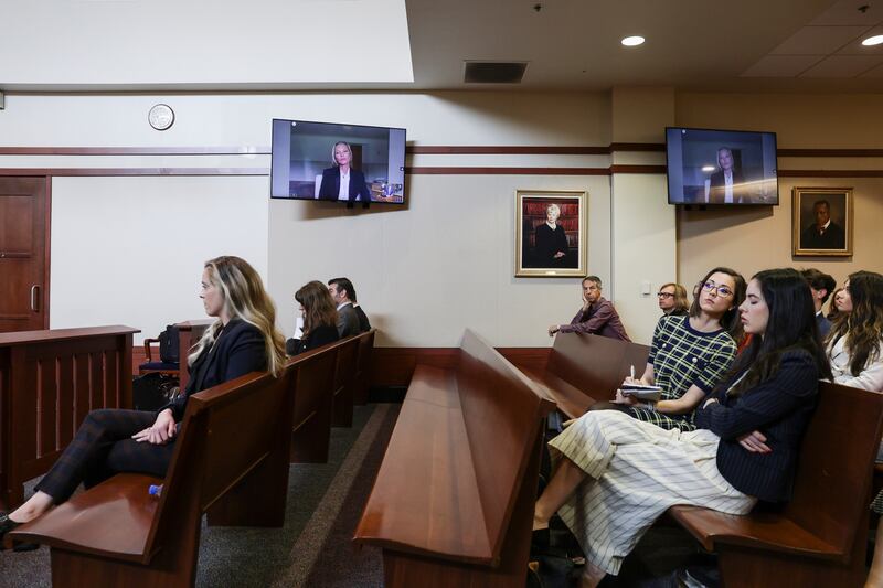 Spectators watch Moss, a former girlfriend of Depp, as she testifies via video link. AP