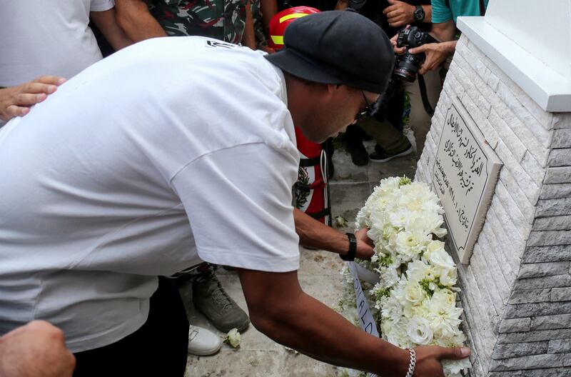 Ronaldinho lays flowers in memory of fire crew members killed during the Beirut port explosion.