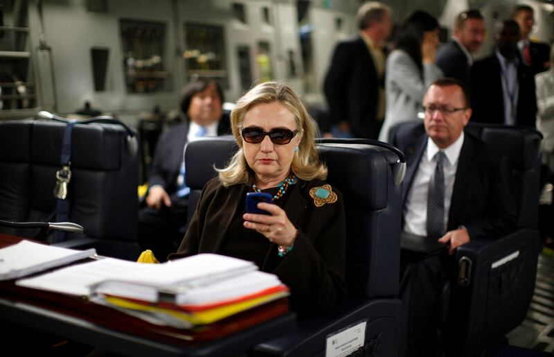 U.S. Secretary of State Hillary Clinton checks her PDA upon her departure in a military C-17 plane from Malta bound for Tripoli,  Libya October 18, 2011. 
REUTERS/Kevin Lamarque  (UNITED STATES - Tags: POLITICS) *** Local Caption ***  SST108_LIBYA-CLINTO_1018_11.JPG