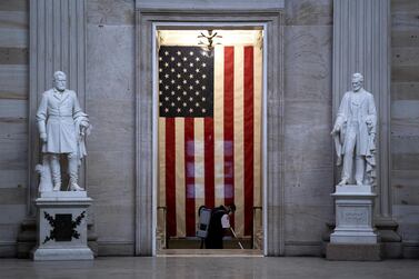 An worker wears a protective mask while cleaning at the U.S. Capitol in Washington, D.C., U.S., on Thursday, Jan. 7, 2021. Joe Biden was formally recognized by Congress as the next U.S. president early Thursday, ending two months of failed challenges by his predecessor, Donald Trump, that exploded into violence at the U.S. Capitol as lawmakers met to ratify the election result. Photographer: Stefani Reynolds/Bloomberg