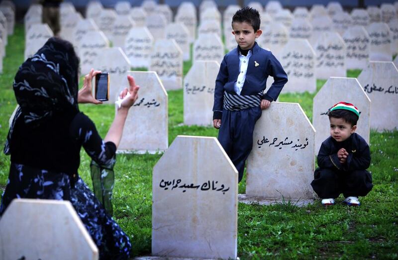 An Iraqi Kurd family visits a grave yard for the victims of a gas attack by former Iraqi president Saddam Hussein in 1988.
