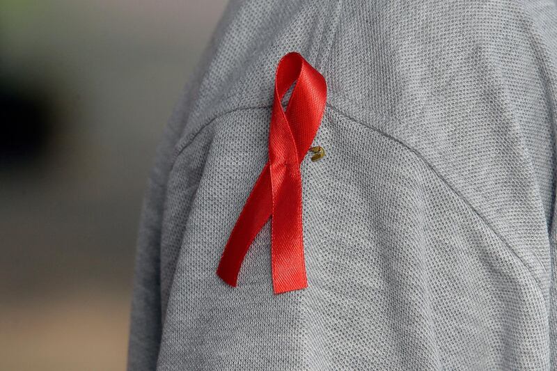 epa08034325 Sri Lankan health workers display red ribbons, an international symbol of human immunodeficiency virus infection and acquired immune deficiency syndrome (HIV/AIDS) awareness, during an AIDS awareness march in Colombo, Sri Lanka, 30 November 2019. World AIDS Day is observed every year on 01 December to raise the awareness in the fight against HIV infection.  EPA/STRINGER