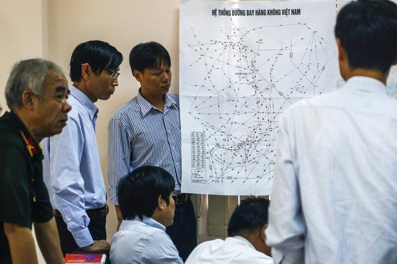 Vietnamese officers discuss a mission brief to find the missing Malaysia Airlines flight MH370 at Phu Quoc Airport on Phu Quoc Island. Athit Perawongmetha / Reuters March 11